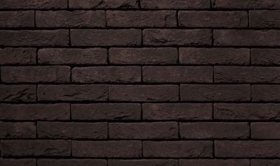 waalformaat metselstenen zwart op een gemetselde muur binnenshuis